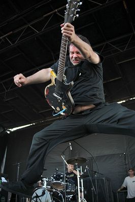 Nicky takes flight on stage on the US Warped tour using his beat up Spruce GS1. Click image to enlarge