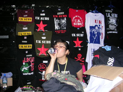 Yuko in  action on the merch stall - click to enlarge